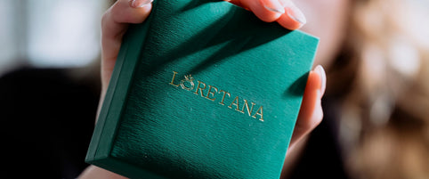 Macro close-up of green Loretana branded jewelry box with gold embossed logo, Lithuanian 925 silver hallmark heritage. Hand-finished piece, Kaunas.