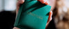 Macro close-up of green Loretana branded jewelry box with gold embossed logo, Lithuanian 925 silver hallmark heritage. Hand-finished piece, Kaunas.