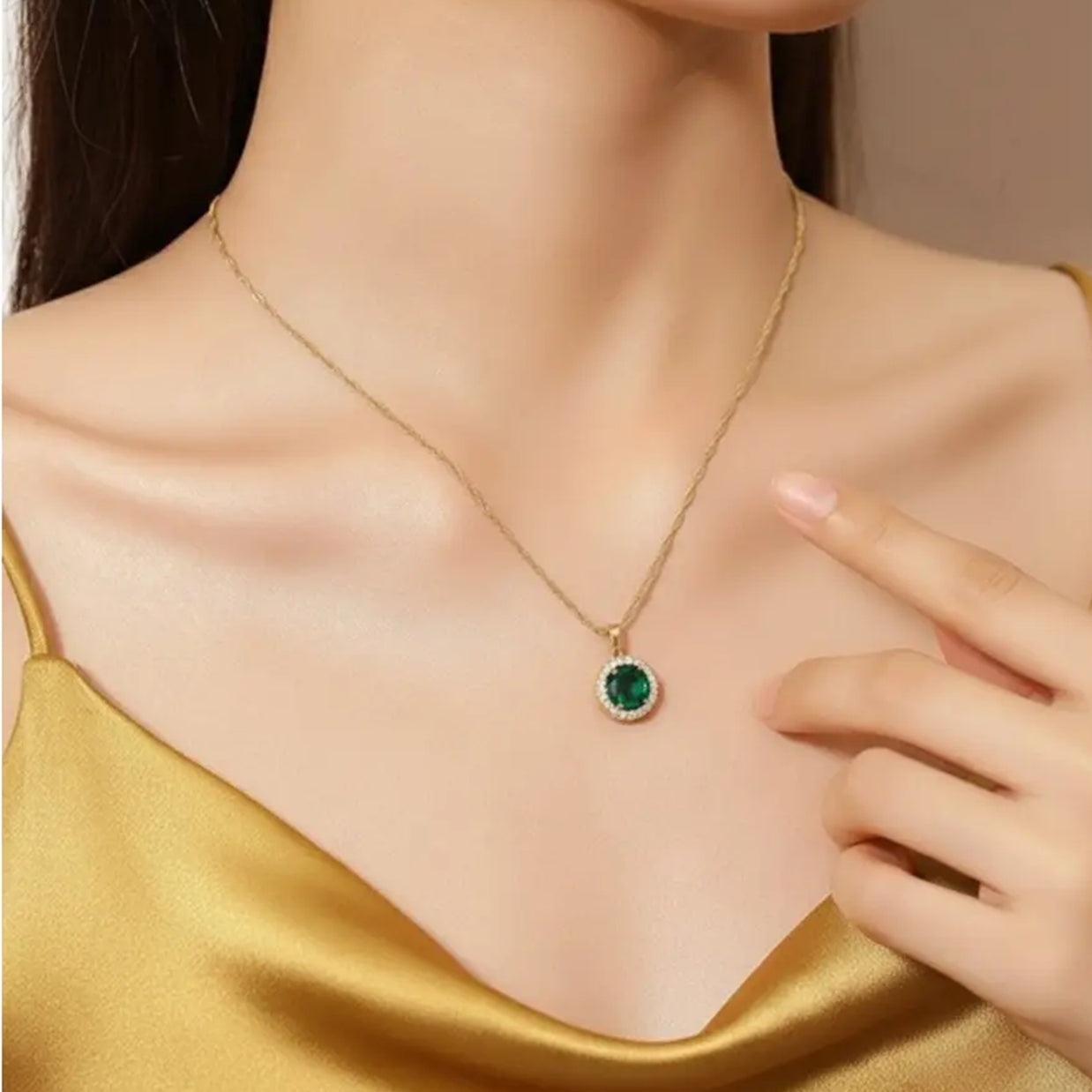 Close up of the 14K Gold Emerald Halo Necklace highlighting the precision-cut AAAAA zirconia and the high-polish 14K gold-plated setting.
