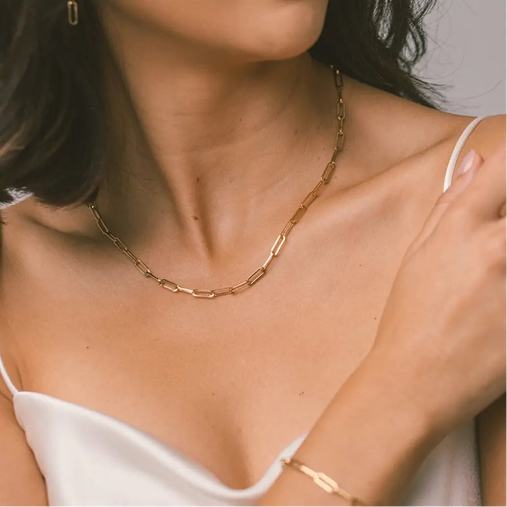 Close up of the 14K Gold Paperclip Chain Necklace showcasing the hallmark and the high-quality clasp construction.