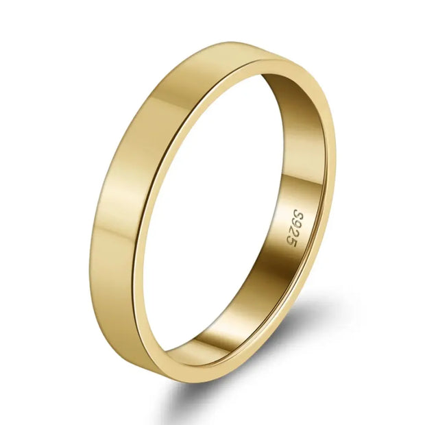 Close-up of the thin gold stacking ring highlighting the polished 3mm engravable band
