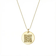 Close up of 14K gold coin necklace showing precision laser engraving surface