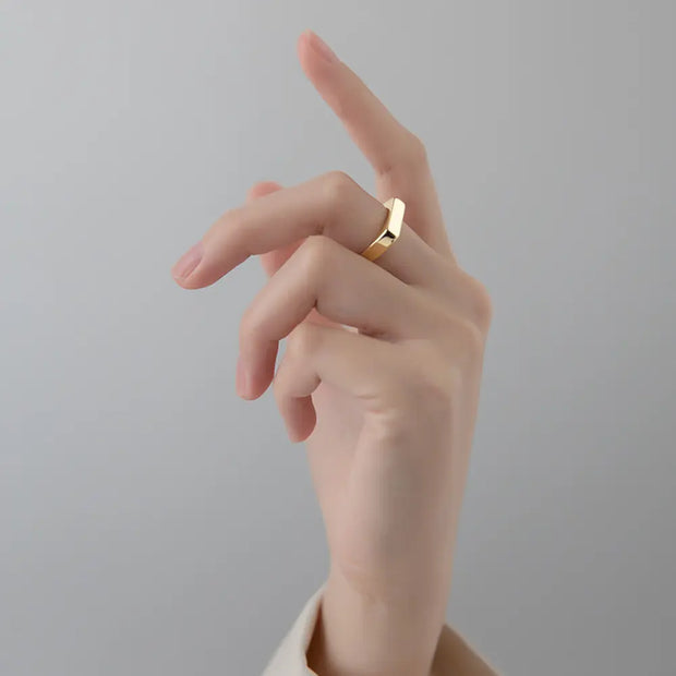 Close-up of the 14K gold rectangle ring highlighting the open-back adjustable band.