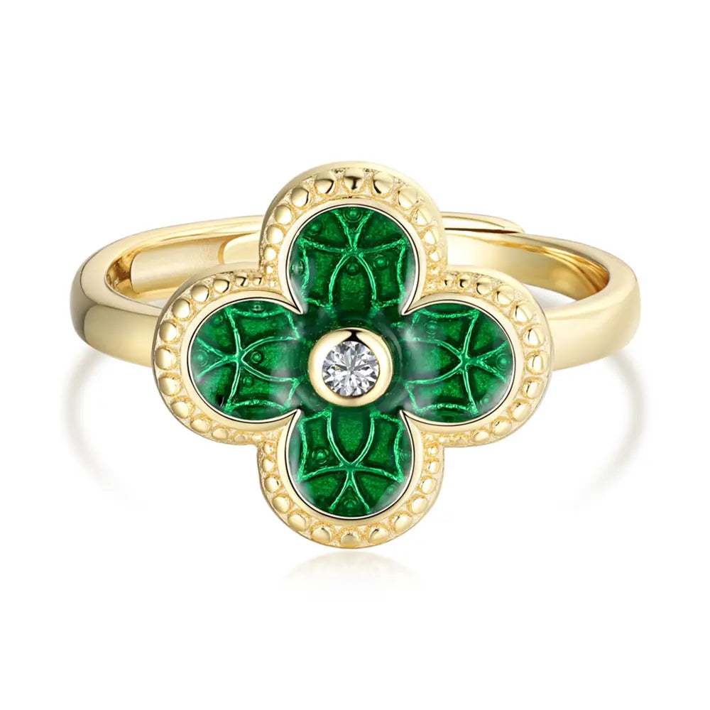 Close-up of a woman's hand wearing the 14K gold-plated silver green four leaf clover ring.