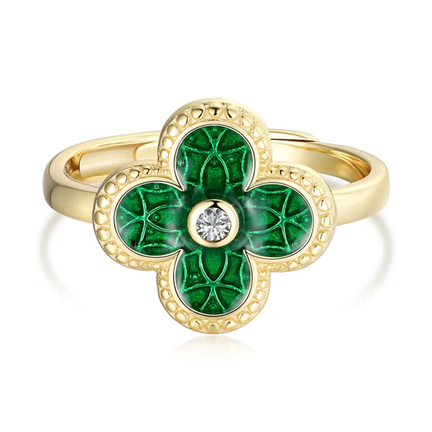 Close-up of a woman's hand wearing the 14K gold-plated silver green four leaf clover ring.