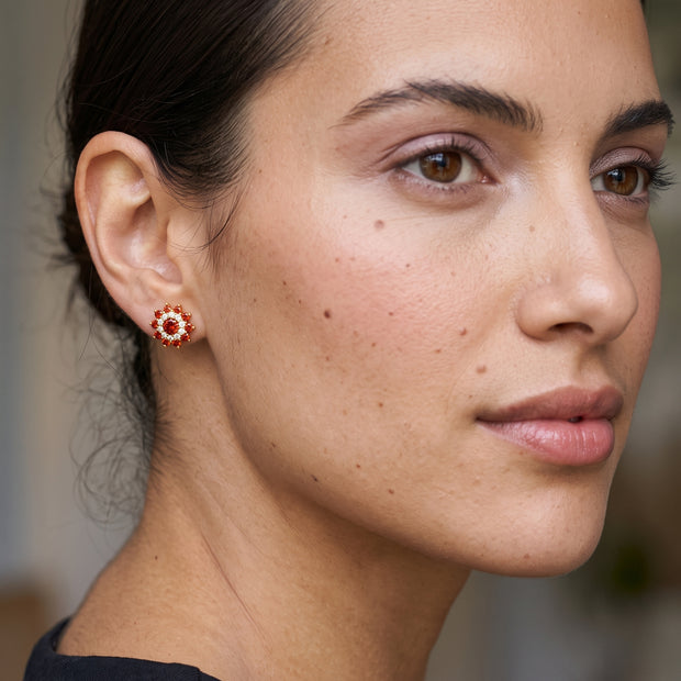 Model wearing red CZ flower stud earring in 14K gold-plated 925 silver