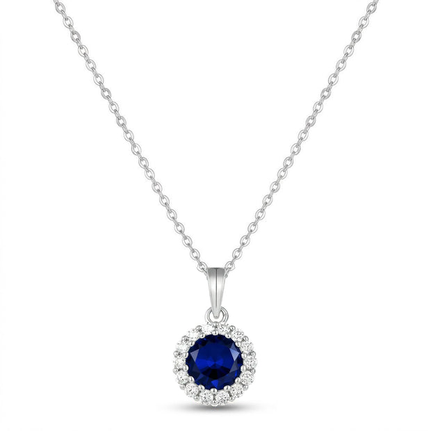 Blue CZ Halo Necklace in rhodium-plated 925 silver: a round deep blue AAAAA cubic zirconia framed by white stones, on a fine chain