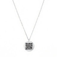 Close-up of the 925 sterling silver round coin pendant with a QR code laser engraved onto the polished surface.