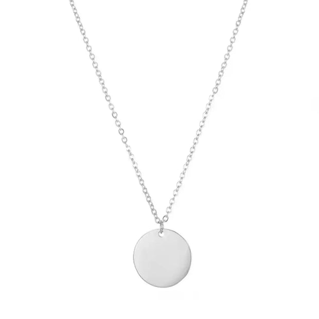 Rhodium-plated 925 sterling silver coin necklace on white, the smooth round disc pendant ready for engraving.