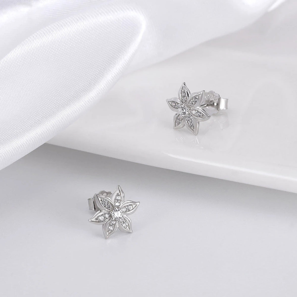 925 silver marquise flower stud earrings with AAAAA cubic zirconia on white satin