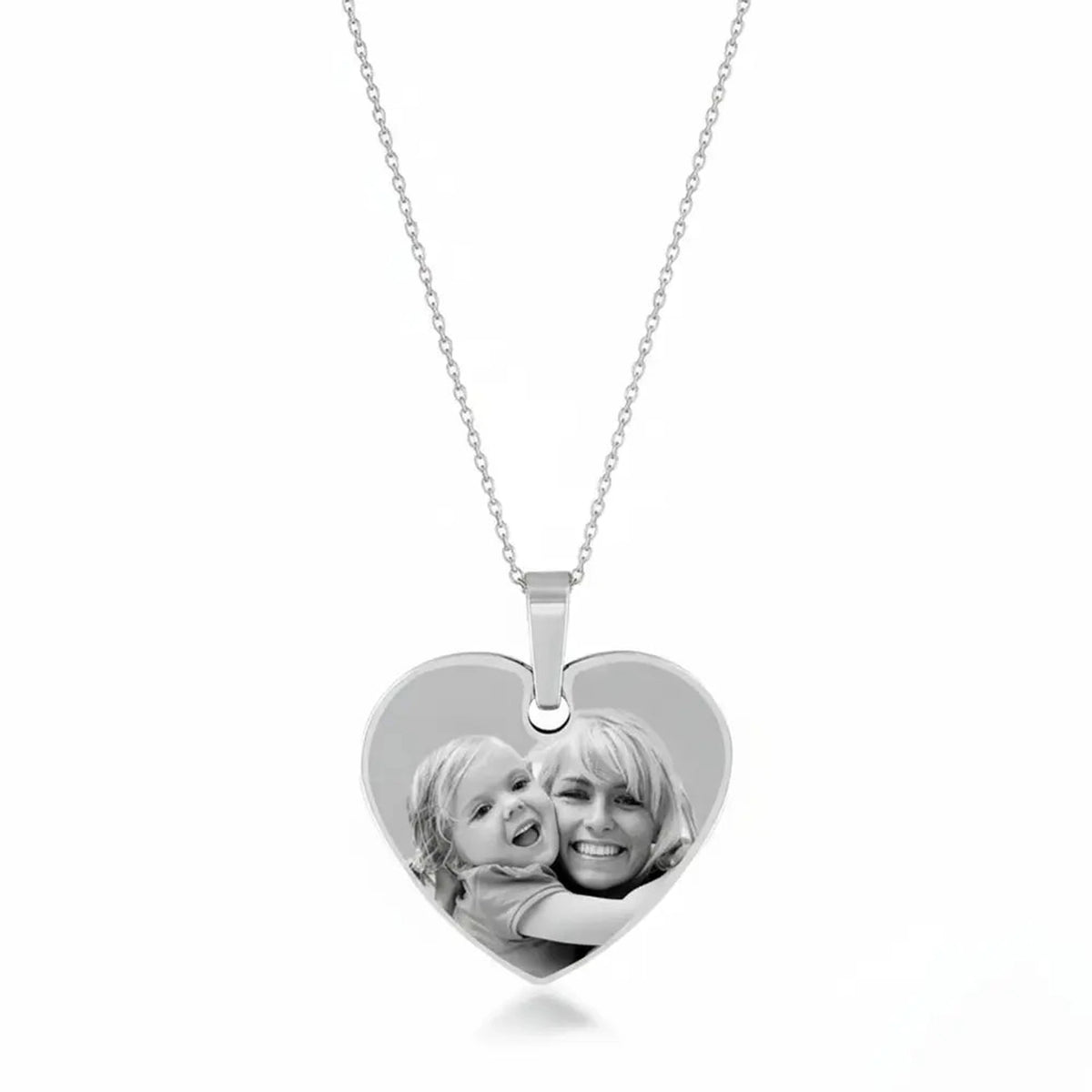 Close-up of the 925 sterling silver heart pendant with a photograph laser engraved onto the polished surface.