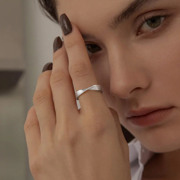 Close-up of the silver twisted knot ring highlighting the pure metal texture.