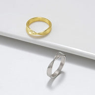 Profile view of a model wearing the minimalist 925 silver twisted knot ring.