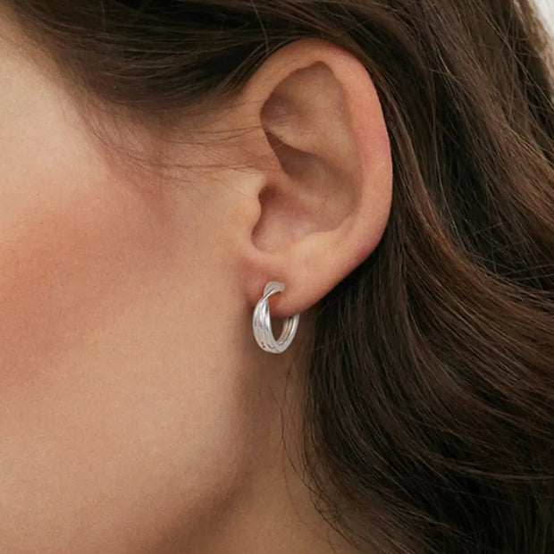 Close up of the 925 Silver Minimalist Hoops highlighting the seamless architectural finish and rhodium hallmark.

