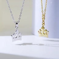 Elegant 18K gold crown pendant necklace styled with an everyday modern wardrobe