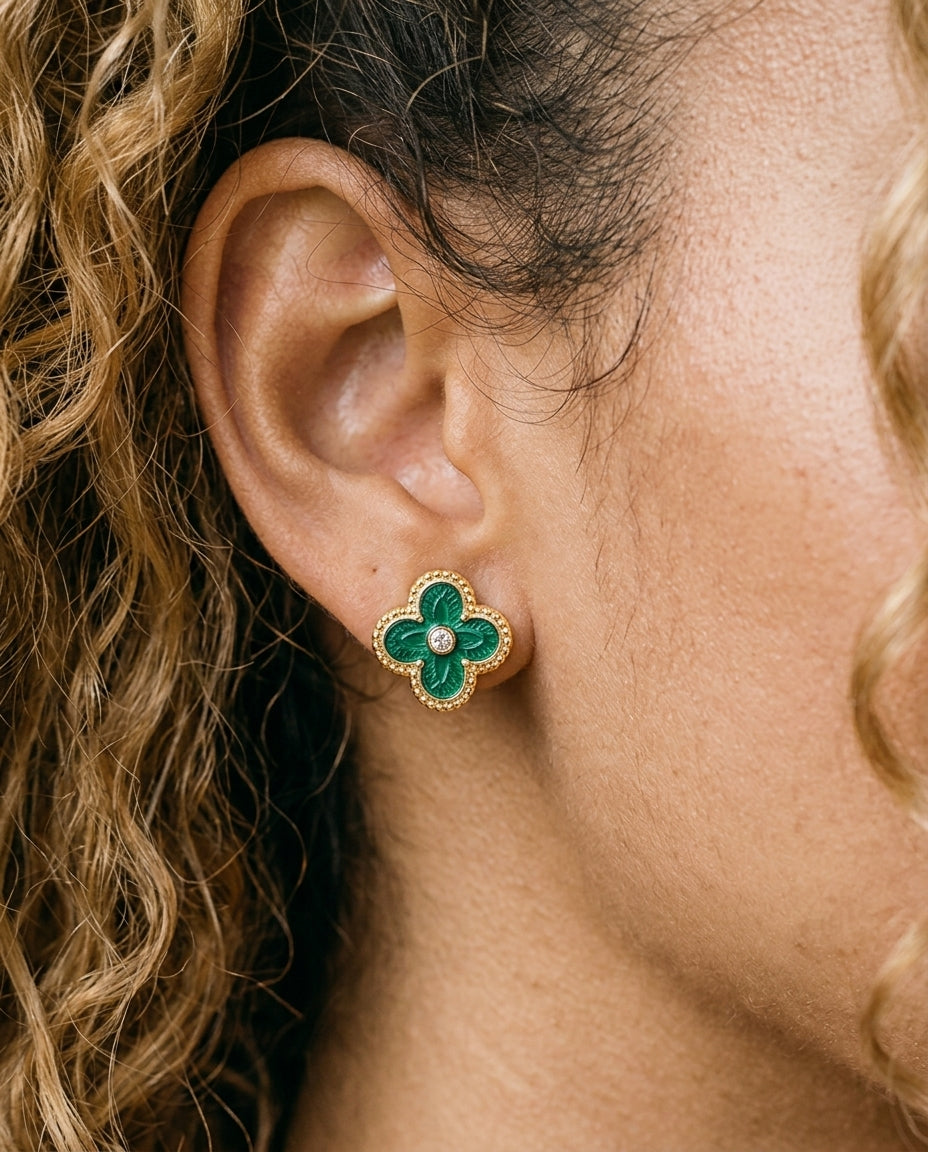 Close-up of green enamel clover stud with beaded gold border and central CZ on the ear