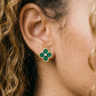 Close-up of green enamel clover stud with beaded gold border and central CZ on the ear