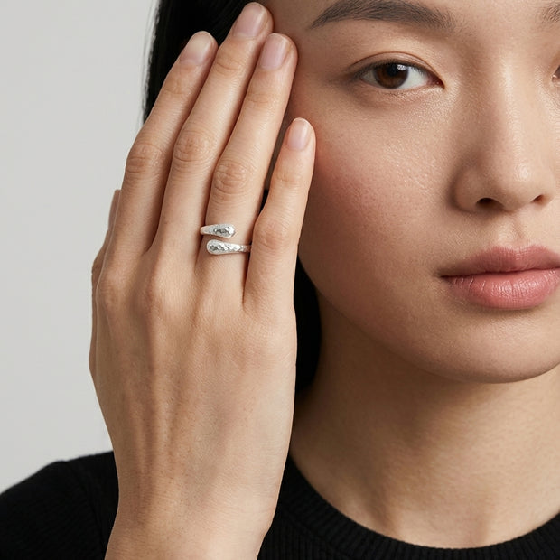 Loretana R36-S hammered teardrop silver wrap ring worn by model, hand at temple