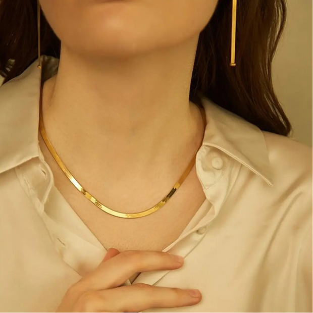 14K Gold Flat Snake Chain Necklace styled with other delicate gold chains to show its versatility in a curated layered stack