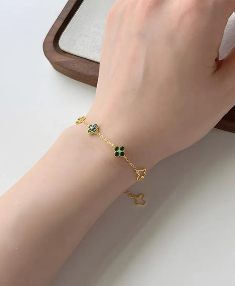 Close up of 14K gold clover bracelet showing precision pavé zirconia setting