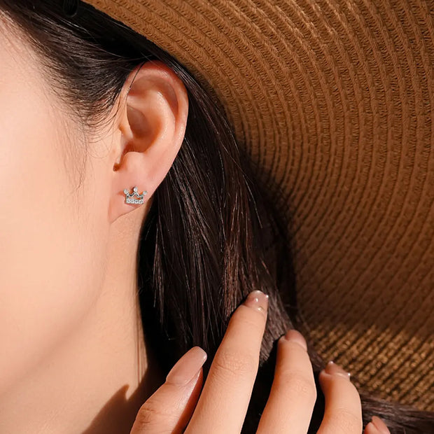 Close up of architectural silver crown stud earrings showing precision zirconia setting