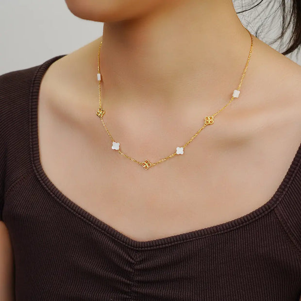 Close up of 14K gold clover necklace showing iridescent shell pearl inlay