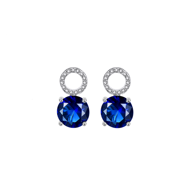 Pair of detachable drops with round deep blue AAAAA cubic zirconia under a pavé ring, on white.