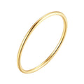Hand wearing stacked 14K gold-plated essential band rings in hallmarked 925 sterling silver.