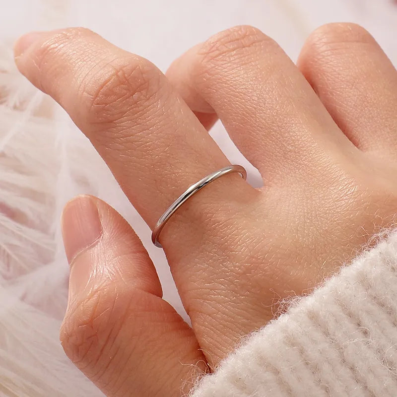 Close-up of the ultra-polished silver stacking band highlighting the hallmarked 925 silver finish.