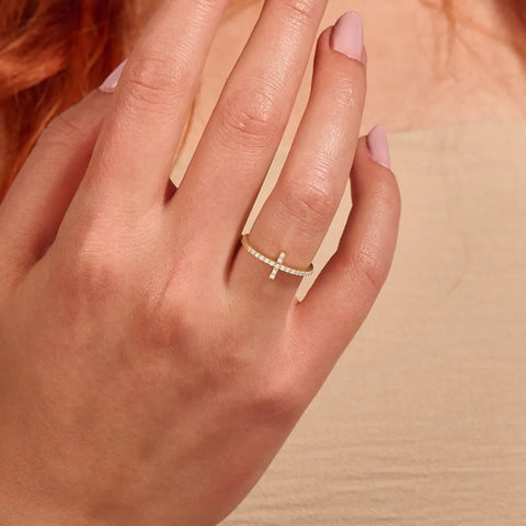 Macro detail of the gold cross zirconia ring showing the AAAAA cubic zirconia within the cross motif, warm 14K gold plating over 925 sterling silver. Hallmarked Loretana piece, hand-finished in Kaunas.