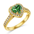 Hand wearing the 14K gold-plated green heart ring, showing the warm band and green AAAAA cubic zirconia heart.