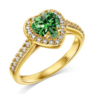 Close-up of a woman's hand wearing the 14K gold-plated green heart ring for a nature-inspired look.