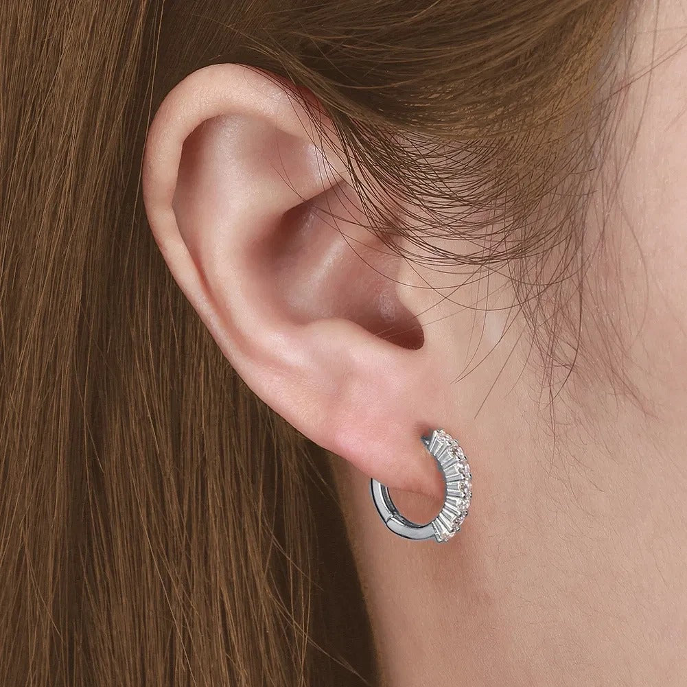 Silver round CZ hoop worn alone on the earlobe, rhodium-plated 925 silver.