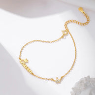 14K gold crown initial bracelet styled in a warm minimalist curated bracelet stack