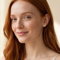 Model wearing the Butterfly Pave Studs, AAAAA CZ in 14K gold-plated 925 sterling silver