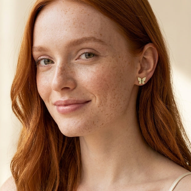 Model wearing the Butterfly Pave Studs, AAAAA CZ in 14K gold-plated 925 sterling silver