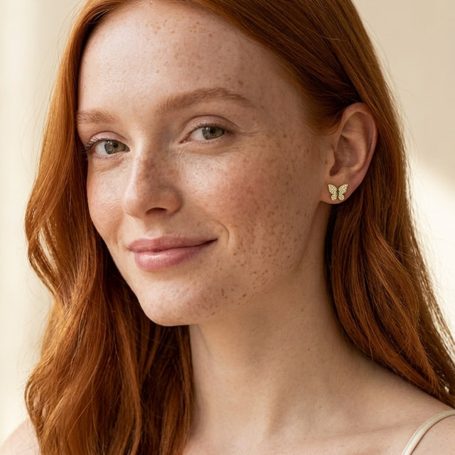 Model wearing the Butterfly Pave Studs, AAAAA CZ in 14K gold-plated 925 sterling silver