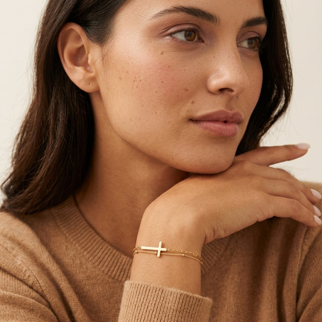 Model wearing the Double Layer Cross Bracelet in 14K gold-plated 925 sterling silver