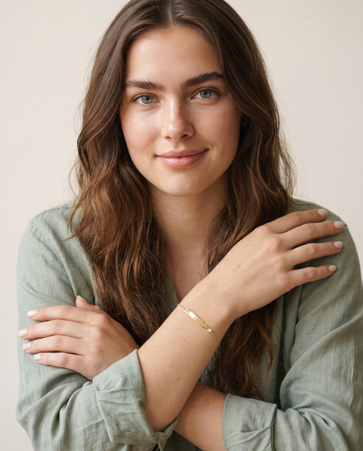 Model wearing the Engraved Curved Bar Bracelet, CZ in 14K gold-plated 925 sterling silver
