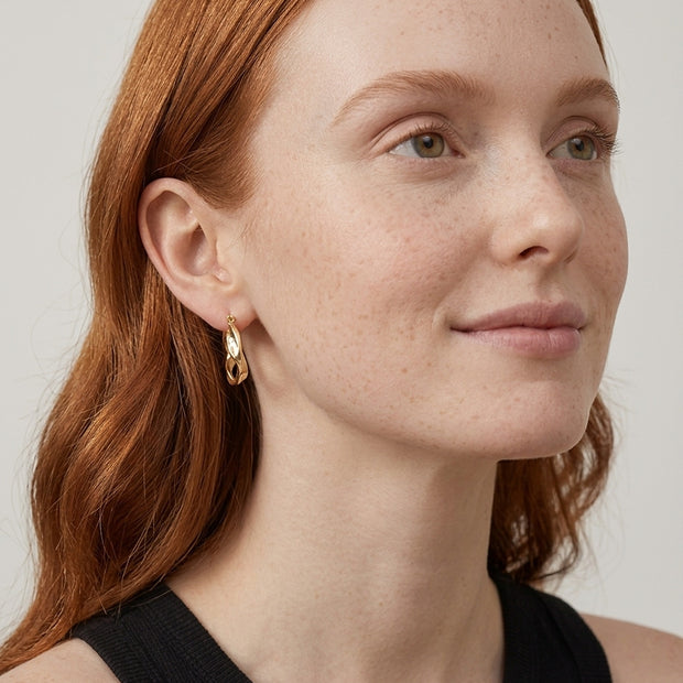 Model wearing the Wavy Sculptural Hoops in 14K gold-plated 925 sterling silver