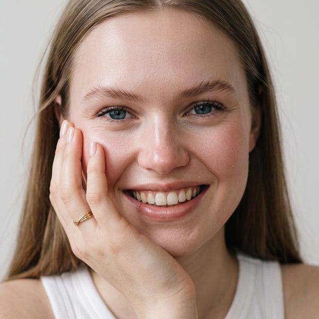 Model wearing the Twisted Knot Stacking Ring in 14K gold-plated 925 sterling silver