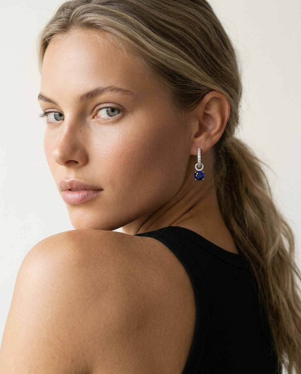 Model wearing the Interchangeable Halo Hoops, Blue CZ in 925 sterling silver