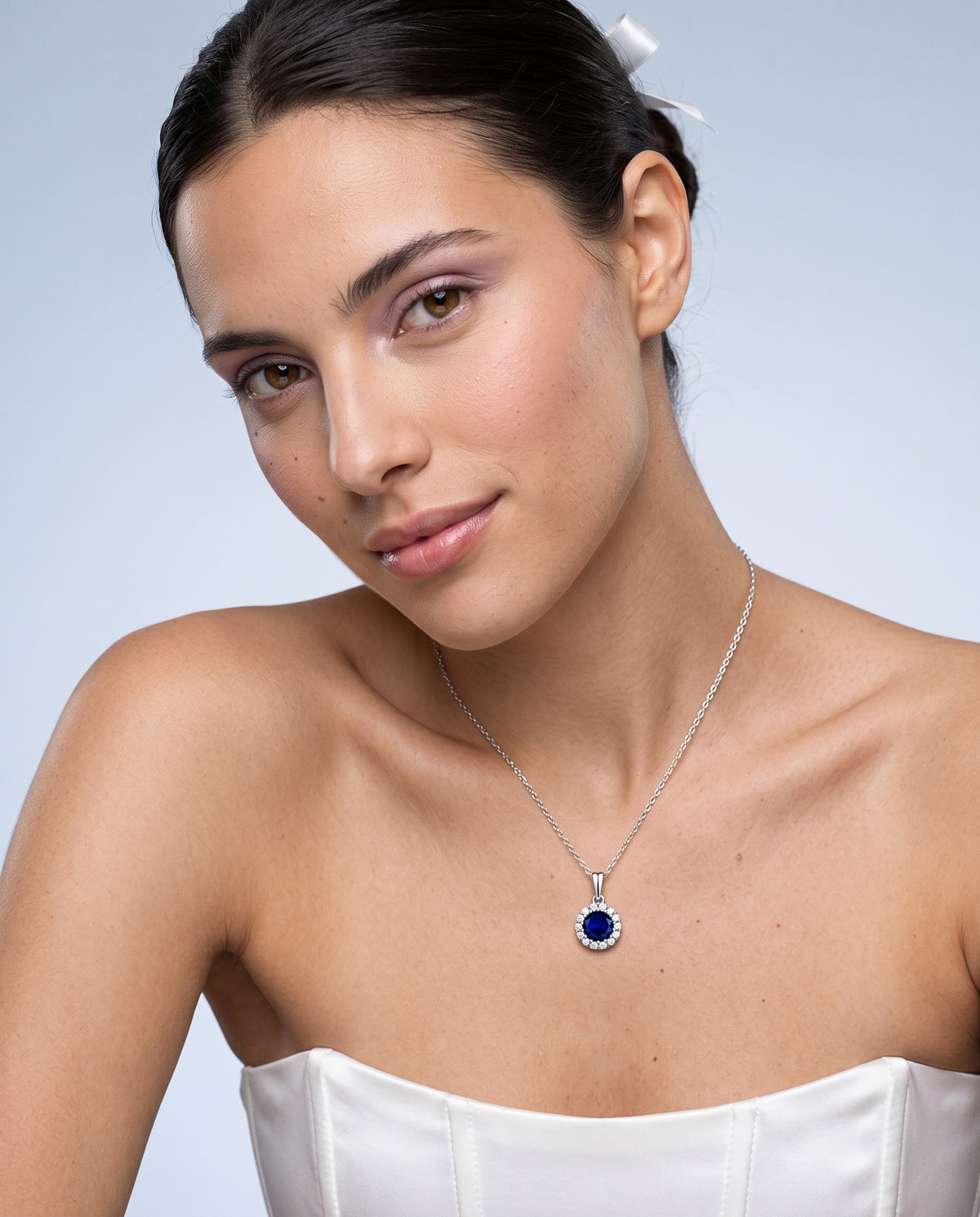 Model wearing the Blue CZ Halo Necklace in 925 sterling silver