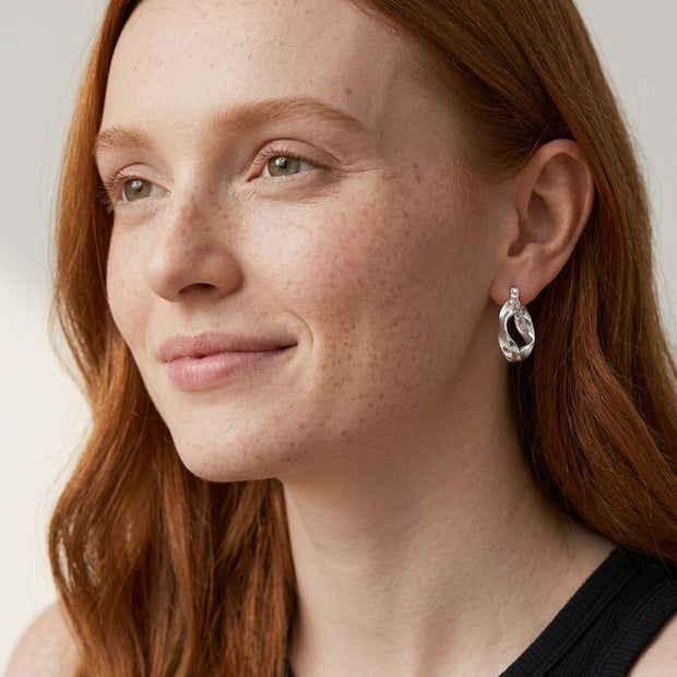 Model wearing the Wavy Sculptural Hoops in 925 sterling silver
