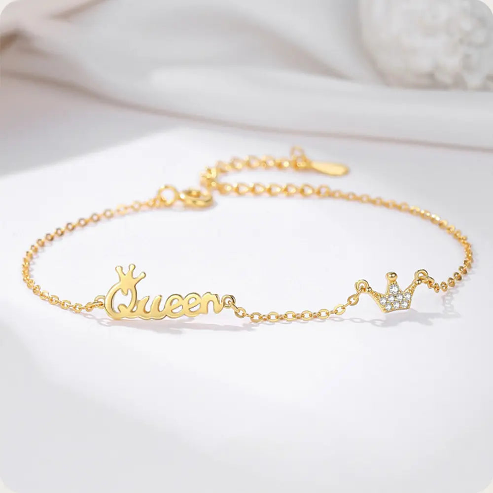 Woman wearing 14K gold crown initial bracelet as a personalized statement piece