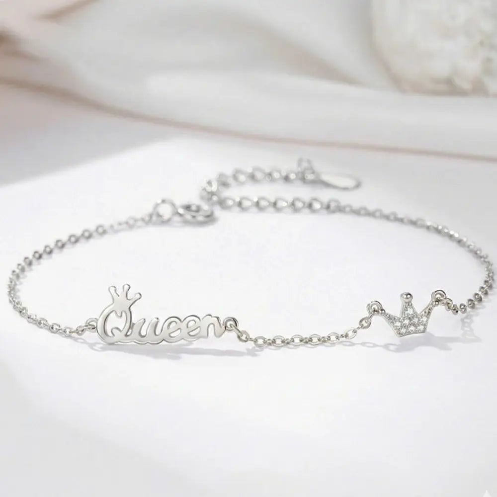 Woman wearing 925 silver crown initial bracelet as a personalized statement piece