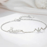 Woman wearing 925 silver crown initial bracelet as a personalized statement piece