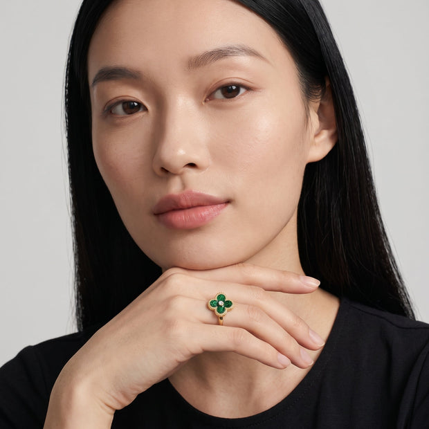 Model wearing the 14K gold-plated green enamel clover ring with beaded gold rim and centre CZ