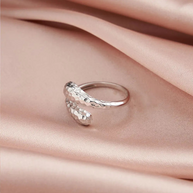 Close-up of a woman's hand wearing the 925 silver snake and teardrop adjustable rings together.